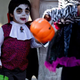 Small boy dressed as vampire trick-or-treating